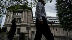 Asian stocks boosted by falling oil, yen weakens after BoJ rate hike