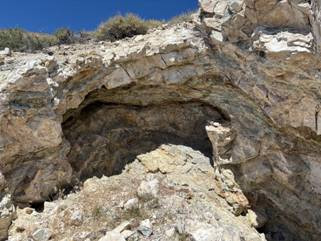 A rock formation with a hole in it AI-generated content may be incorrect.